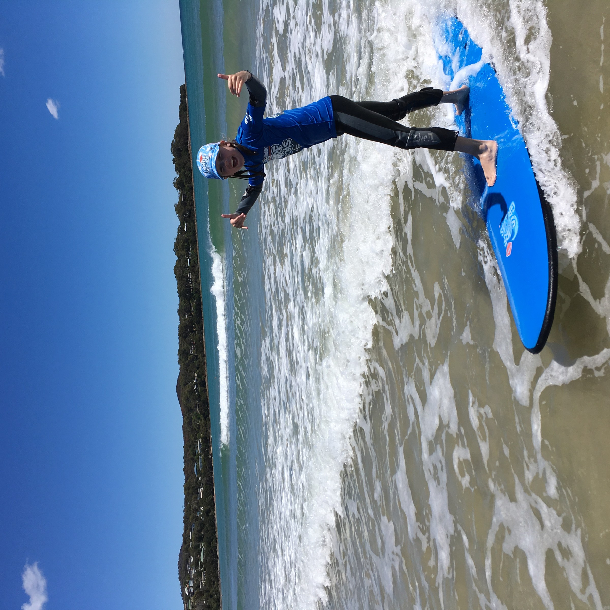 A younger surfer enjoying a SurfGrom lesson